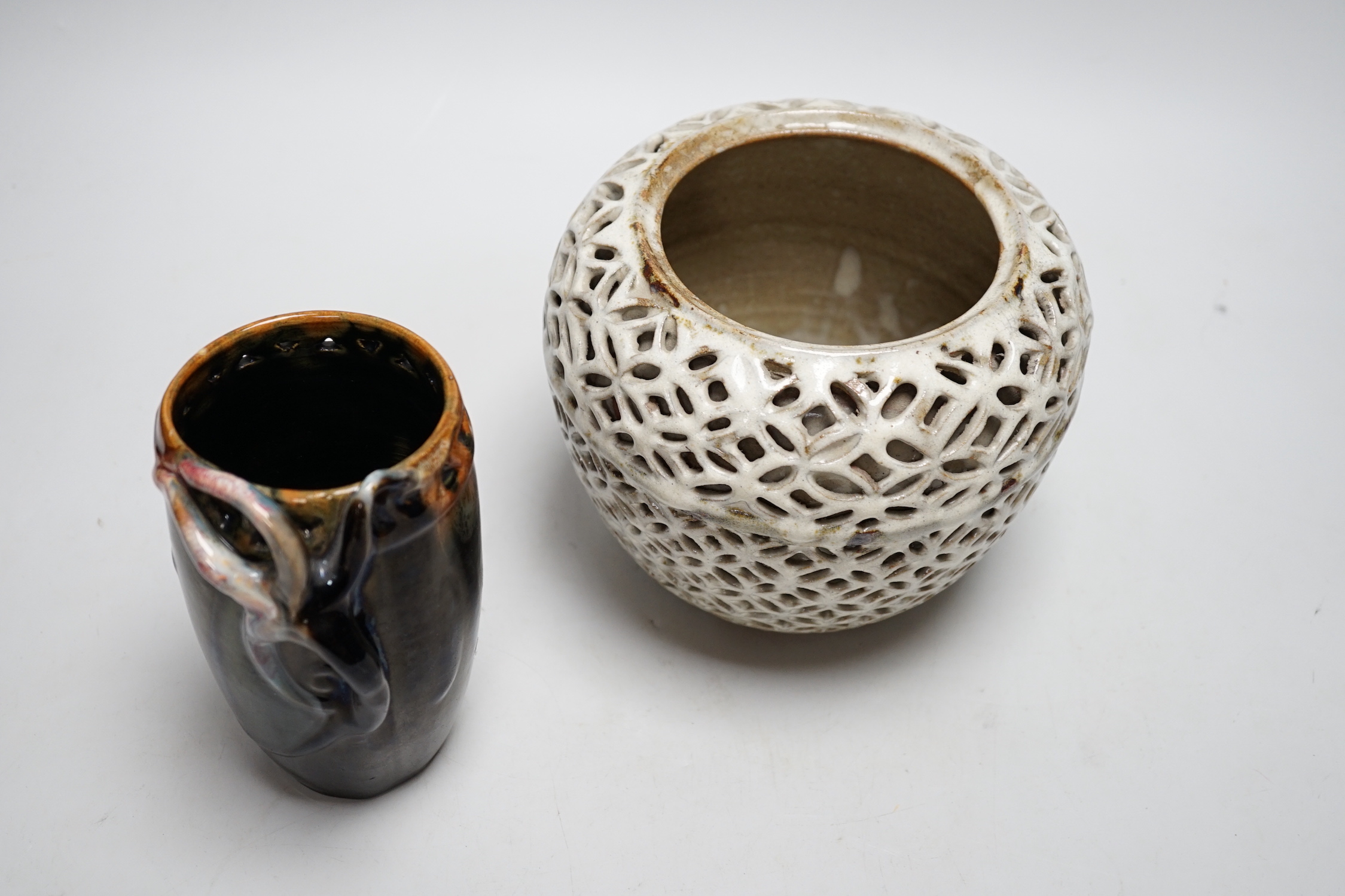 A reticulated art pottery vase and another pottery vase, largest 15cm high